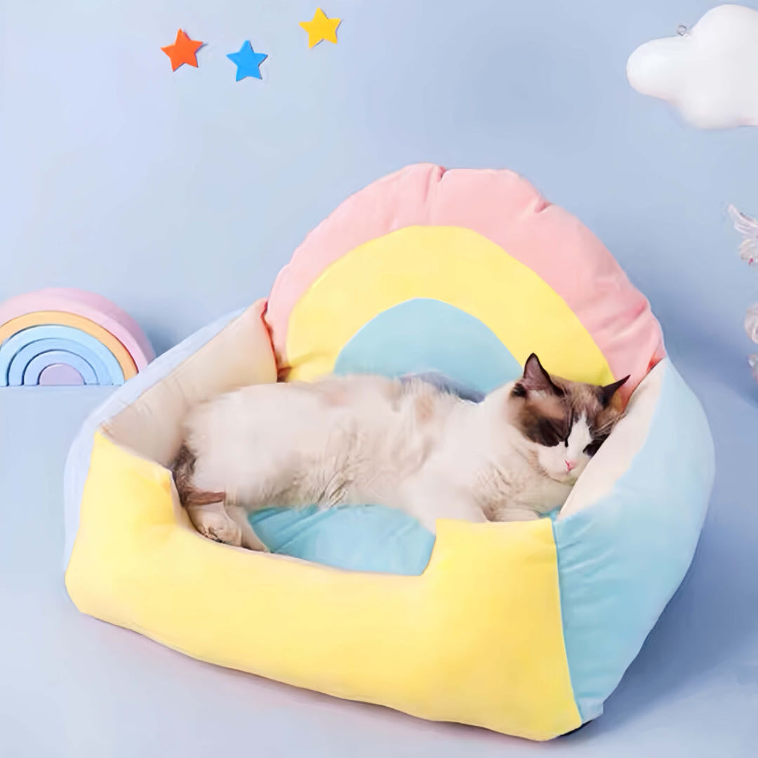 A cat is Sleeping in a rainbow coloured cat sofa bed