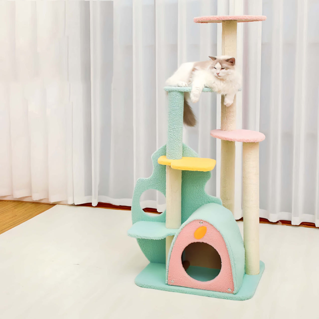 A Cat Lying On A Large Size Green Colour Cat Tree with Scratching Post And Nest