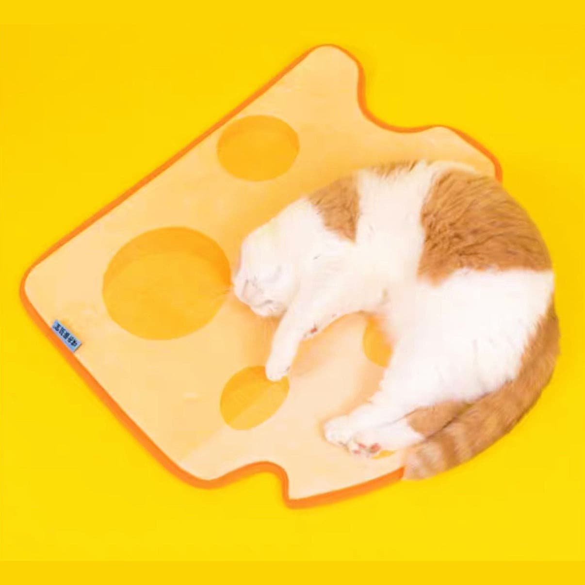 A Cat Sleeping On A Cheesecake Shaped Pet Sleeping Mat