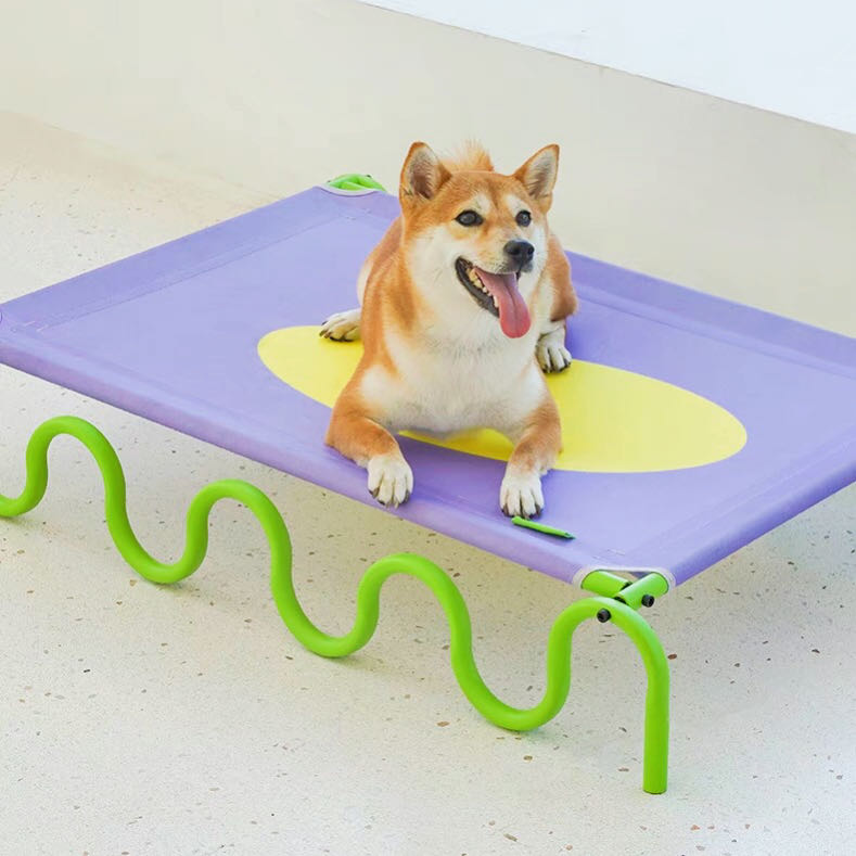 A dog lying on a Stylish Pet Wave-Style Elevated Dog Bed petvibez